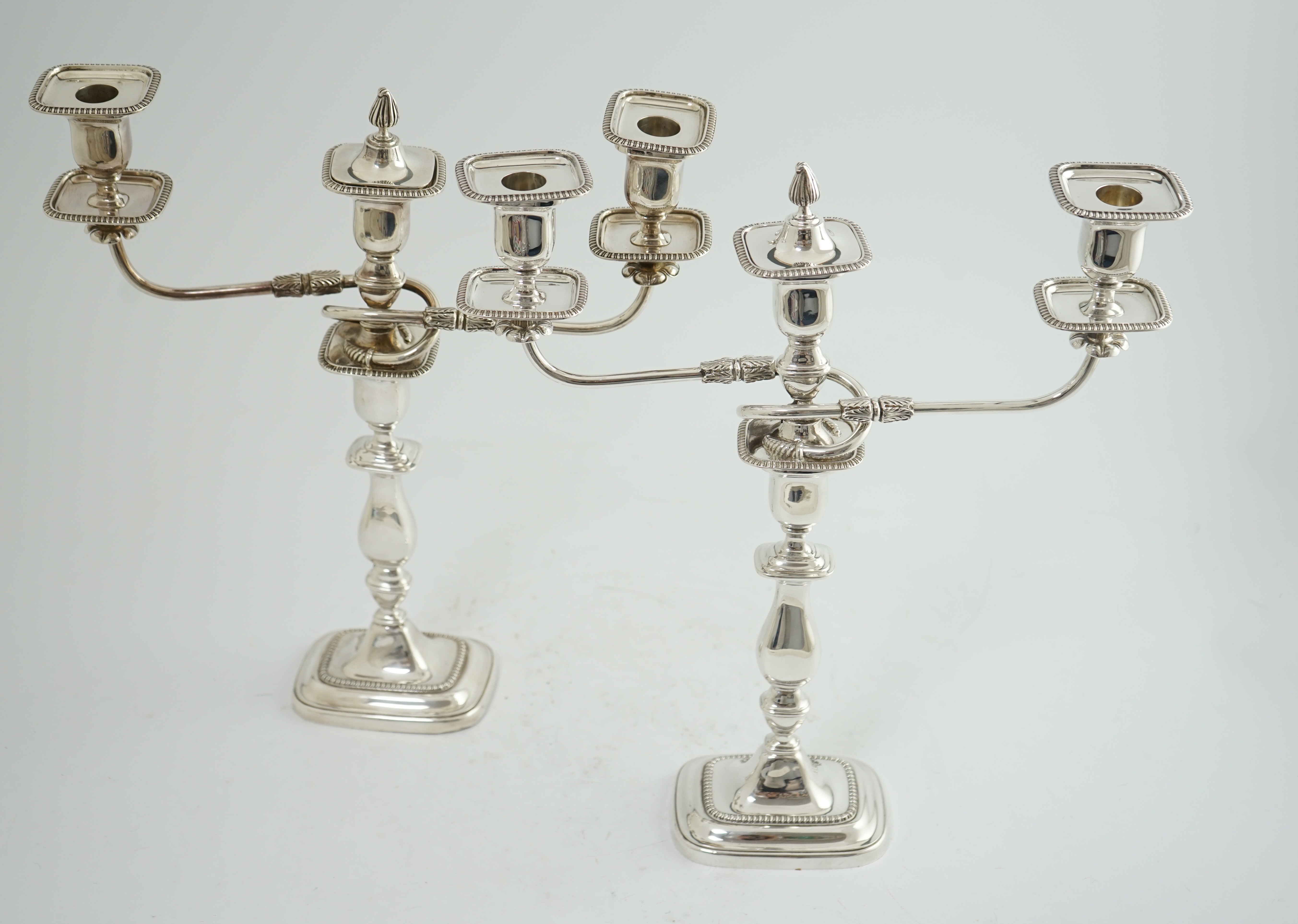 A pair of Elizabeth II silver two branch two light candelabra, by James Dixon & Sons